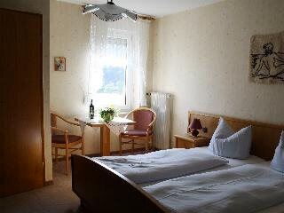 Gästezimmer mit Fenster und Sitzgelegenheit